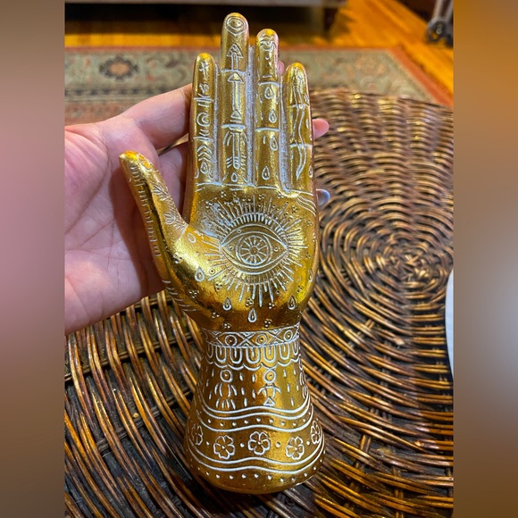 Gold henna hand statue with white 👁️🌖 motifs. - Picture 1 of 5